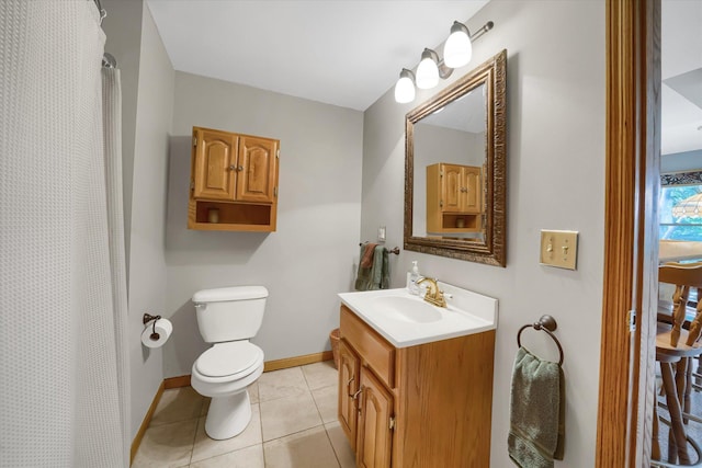 bathroom with tile patterned floors, baseboards, toilet, and vanity