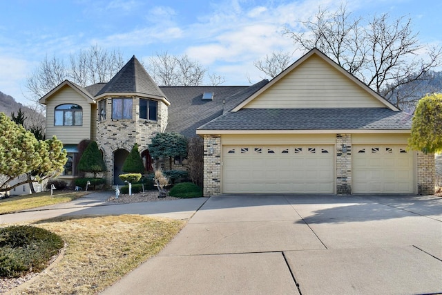 view of front of property featuring brick siding, concrete driveway, an attached garage, and a shingled roof