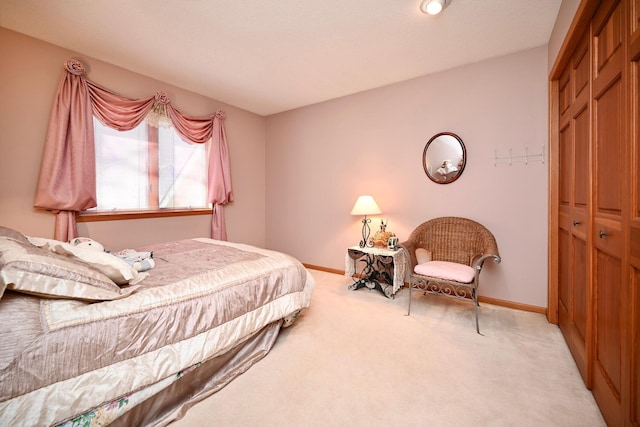 bedroom featuring a closet, baseboards, and carpet