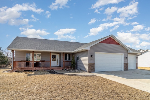 ranch-style home featuring a shingled roof, covered porch, concrete driveway, a front yard, and an attached garage