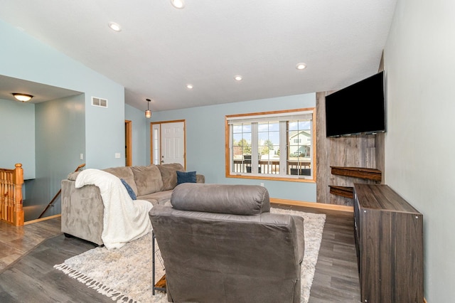 living room featuring recessed lighting, visible vents, lofted ceiling, and wood finished floors