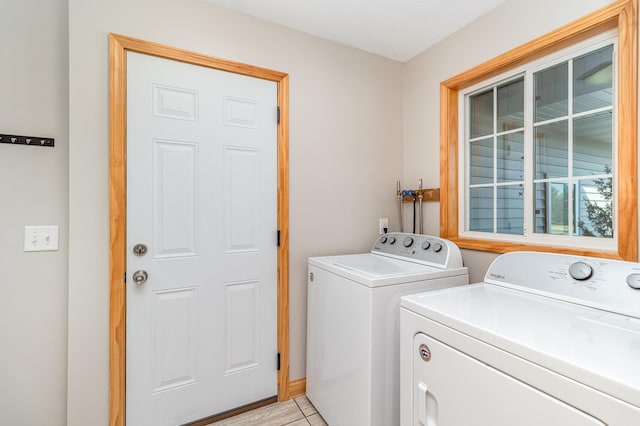 laundry area with light tile patterned floors, washing machine and dryer, and laundry area