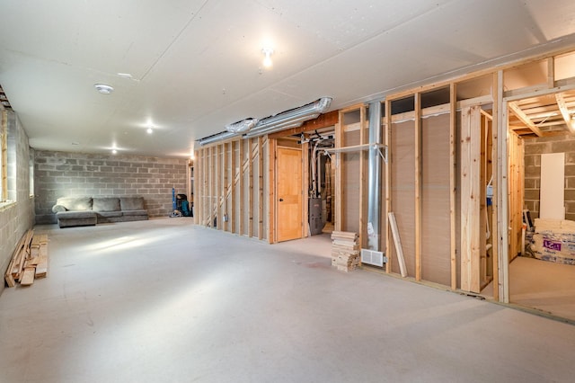 unfinished basement with concrete block wall