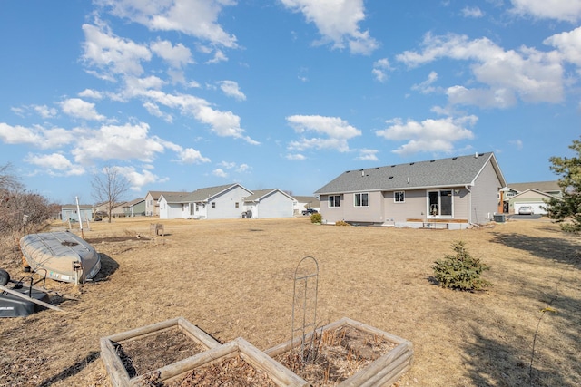 view of yard featuring a residential view and a vegetable garden