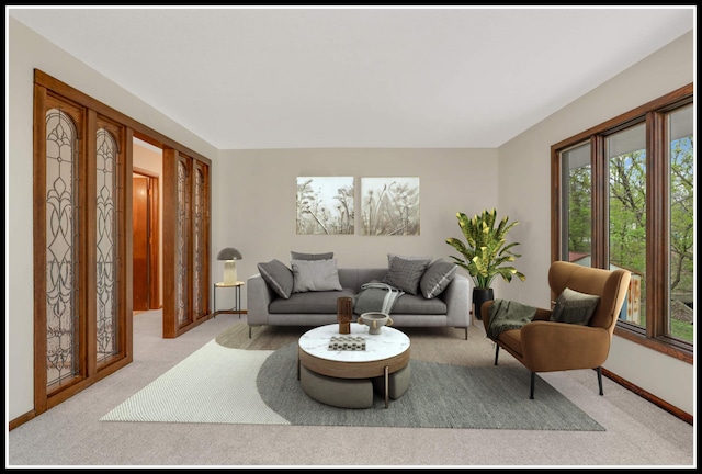living area featuring baseboards and light carpet