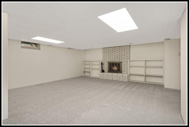 finished below grade area with carpet flooring and a fireplace