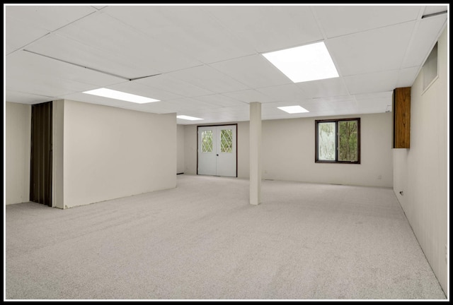 below grade area with carpet and a drop ceiling