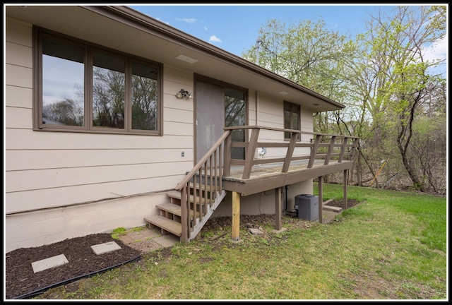 doorway to property featuring central air condition unit, a wooden deck, and a lawn