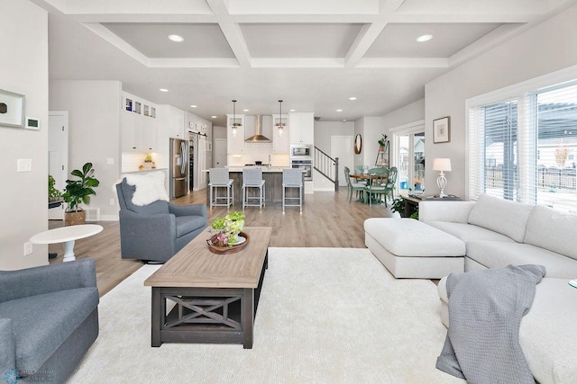 living room with baseboards, beamed ceiling, recessed lighting, light wood-style floors, and coffered ceiling