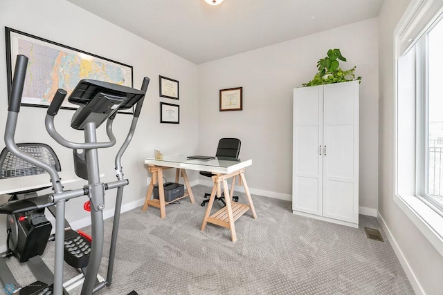 office featuring visible vents, light colored carpet, and baseboards