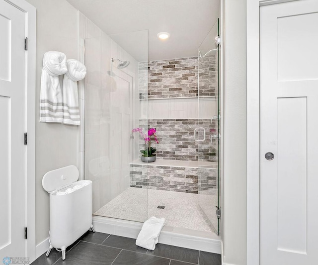 full bath with tile patterned floors and a shower stall