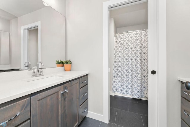 full bathroom featuring curtained shower, baseboards, toilet, tile patterned floors, and vanity