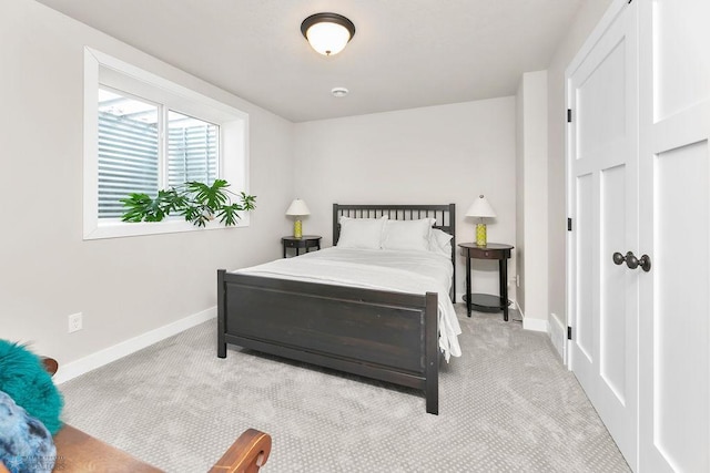 bedroom with carpet flooring and baseboards