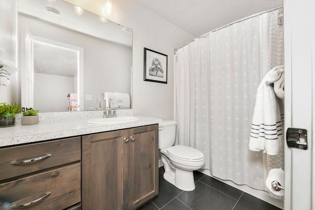 bathroom featuring curtained shower, toilet, vanity, and tile patterned flooring