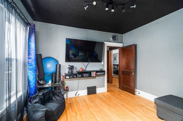 interior space with wood finished floors and baseboards