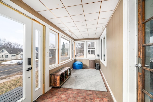 sunroom featuring a wealth of natural light and a paneled ceiling