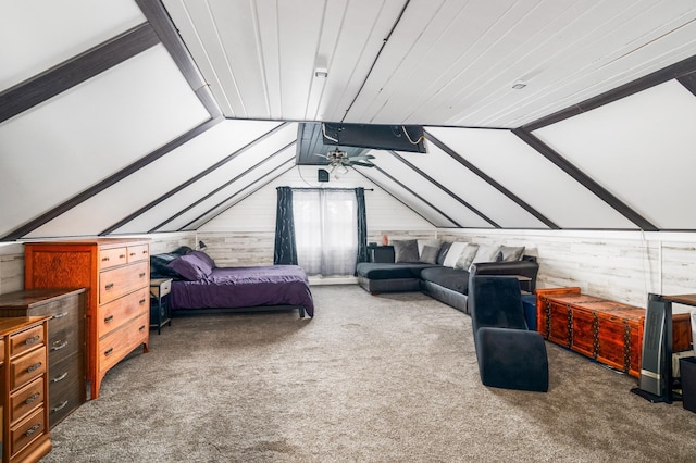 bedroom featuring wood walls, carpet, and vaulted ceiling