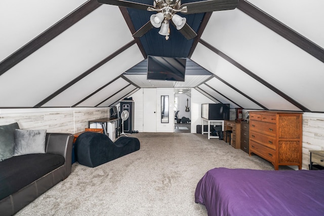 bedroom featuring wooden walls, vaulted ceiling with beams, and carpet floors