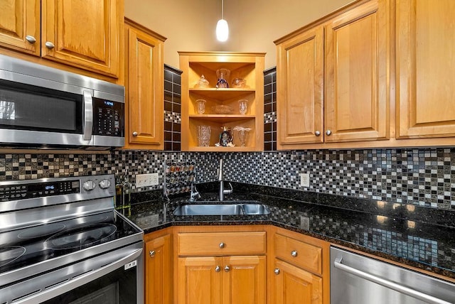 kitchen featuring brown cabinets, a sink, open shelves, appliances with stainless steel finishes, and decorative backsplash