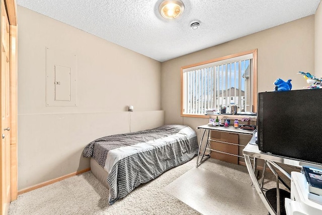 bedroom featuring electric panel, carpet flooring, a textured ceiling, and baseboards