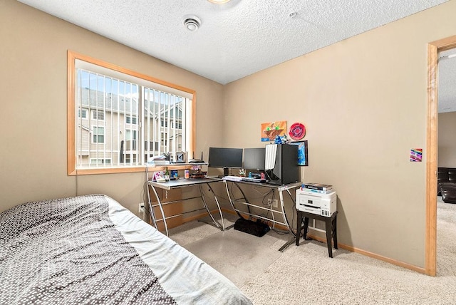 carpeted bedroom with baseboards and a textured ceiling