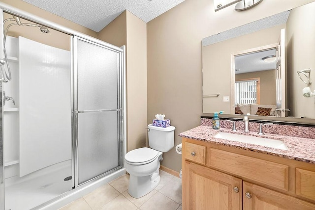 bathroom featuring a textured ceiling, toilet, a shower stall, and tile patterned flooring