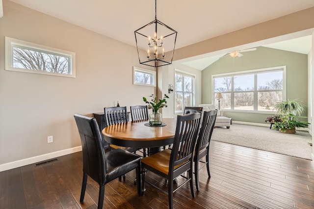 dining space with visible vents, lofted ceiling, baseboards, dark wood finished floors, and a notable chandelier