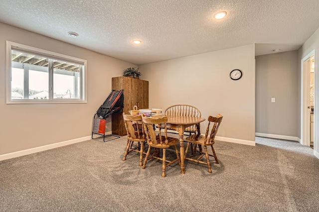 carpeted dining room featuring baseboards, recessed lighting, and a textured ceiling