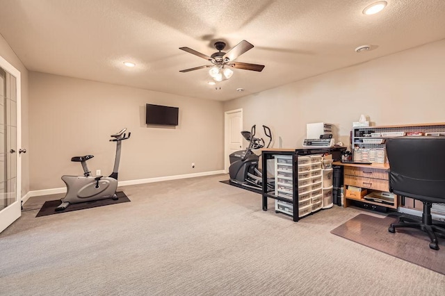 office featuring baseboards, a ceiling fan, carpet, and a textured ceiling