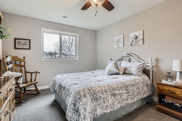 bedroom with dark colored carpet, a ceiling fan, and baseboards