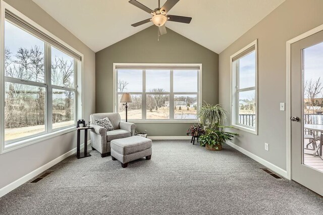 sunroom / solarium with carpet flooring, baseboards, visible vents, and vaulted ceiling