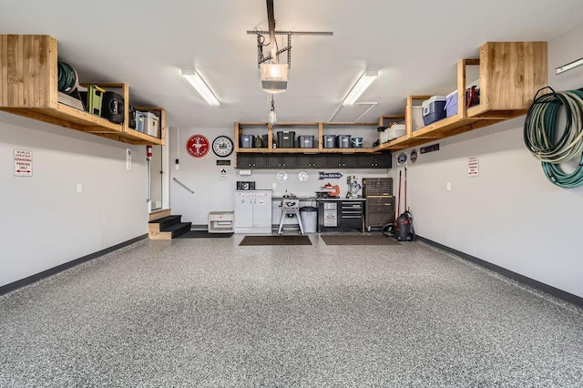 garage with baseboards and a garage door opener