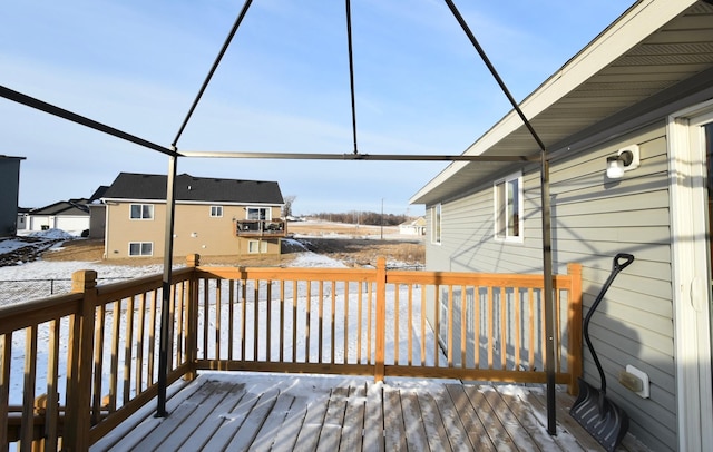 snow covered deck featuring glass enclosure