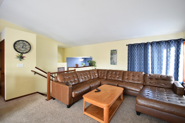 carpeted living room featuring baseboards and vaulted ceiling
