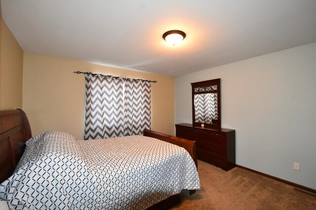 bedroom featuring baseboards and carpet flooring