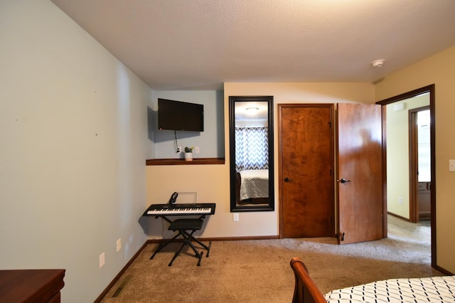 bedroom featuring visible vents, baseboards, and carpet