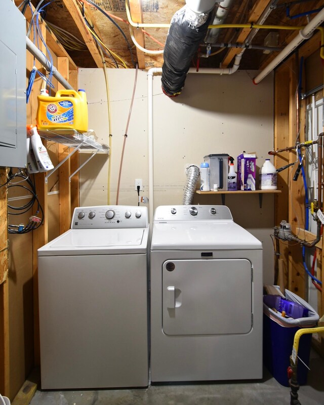 clothes washing area featuring washer and clothes dryer and laundry area