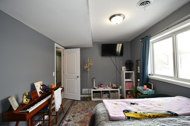 bedroom with visible vents and wood finished floors
