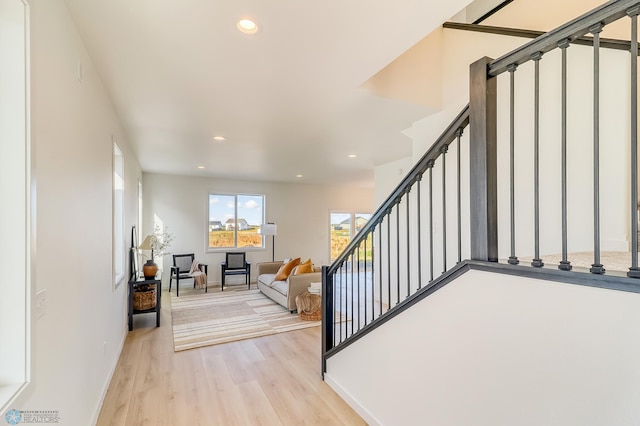 stairway featuring recessed lighting, baseboards, and wood finished floors