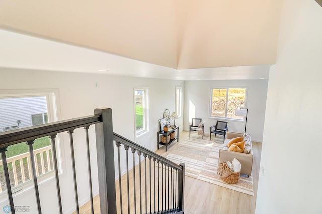 stairs with a high ceiling and wood finished floors