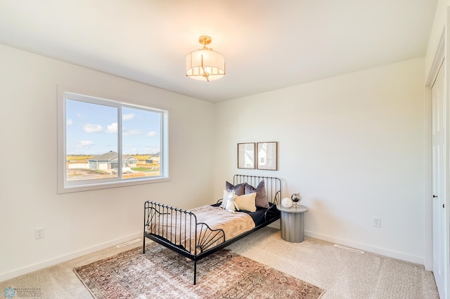 bedroom featuring baseboards and carpet