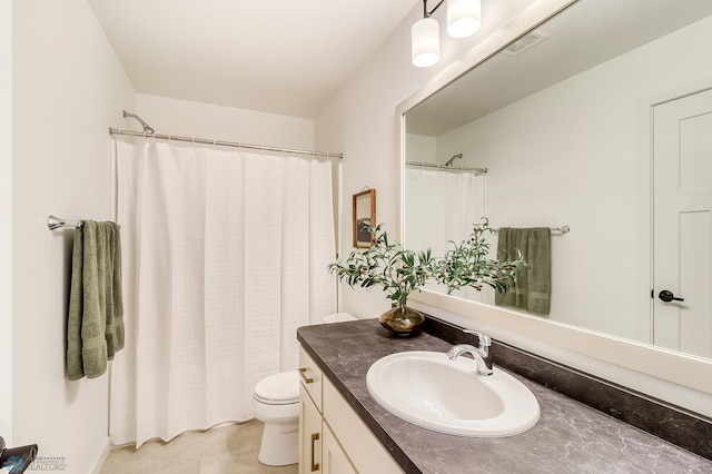 bathroom featuring visible vents, toilet, and vanity