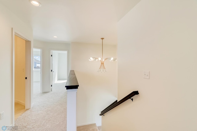 stairs with recessed lighting, an inviting chandelier, and carpet floors