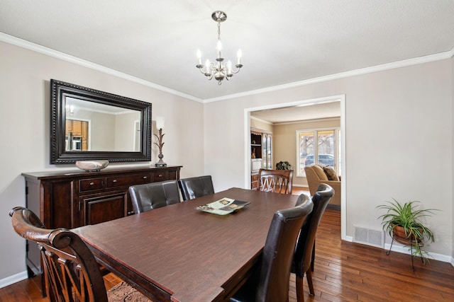 dining area with dark wood finished floors, baseboards, visible vents, and a chandelier