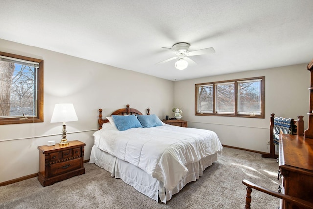 carpeted bedroom featuring a ceiling fan and baseboards