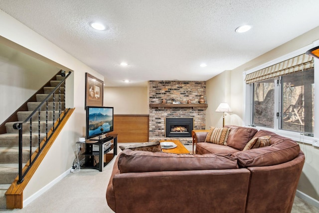 carpeted living room featuring stairway, recessed lighting, a brick fireplace, and a textured ceiling