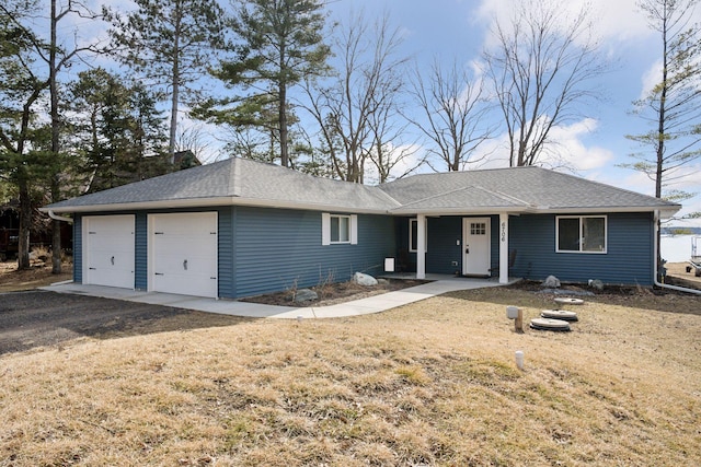 single story home with a front lawn, a garage, and roof with shingles