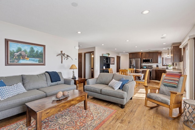 living area featuring recessed lighting and light wood-style floors