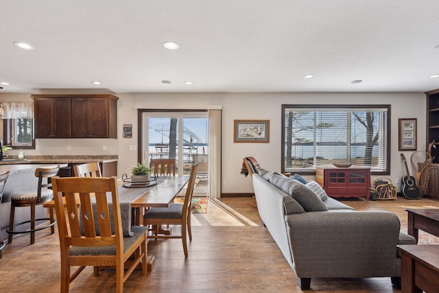 dining area featuring recessed lighting, light wood-type flooring, and baseboards