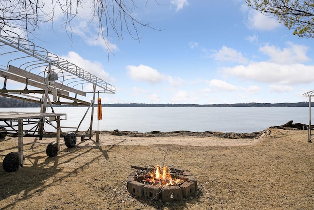 property view of water featuring an outdoor fire pit